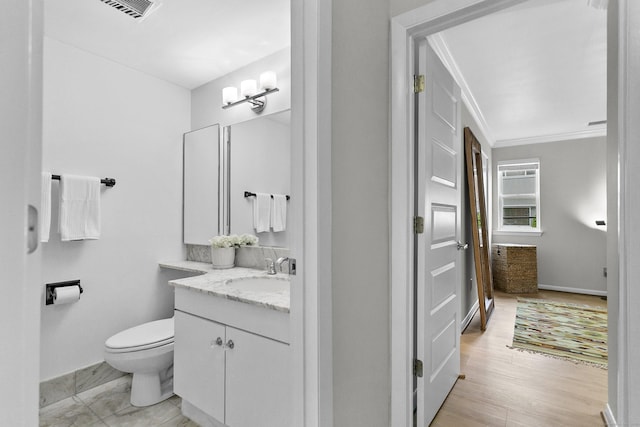 116 Southport Woods Dr, Fairfield, CT 06890 - bathroom with vanity, toilet, crown molding, wood finished floors, and baseboards