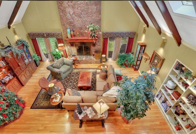 846 Arbutus St, Middletown, CT 06457 - living area with high vaulted ceiling, beamed ceiling, wood finished floors, a stone fireplace, and ornamental molding