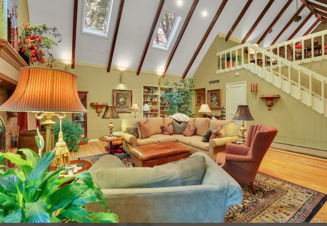 846 Arbutus St, Middletown, CT 06457 - living area with wood finished floors, a skylight, beamed ceiling, stairs, and high vaulted ceiling