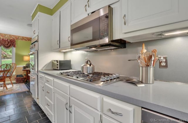 846 Arbutus St, Middletown, CT 06457 - kitchen with appliances with stainless steel finishes, dark stone finish flooring, white cabinets, and light countertops