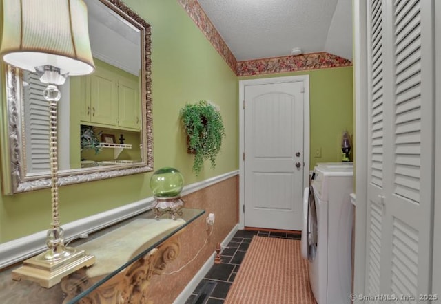 846 Arbutus St, Middletown, CT 06457 - laundry room with washing machine and clothes dryer, a textured ceiling, and cabinet space