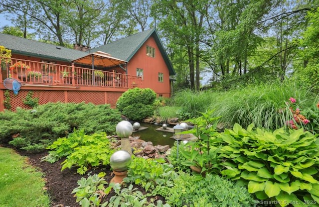846 Arbutus St, Middletown, CT 06457 - view of property exterior with a wooden deck and a garden pond