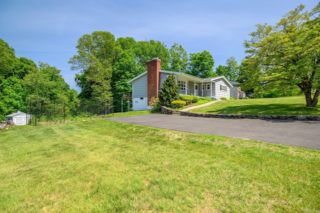 66 Hobby Dr, Ridgefield, CT 06877 - view of side of home with a chimney, a yard, and covered porch