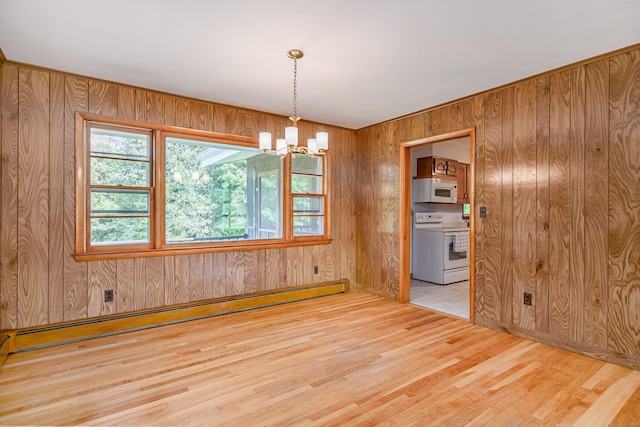 66 Hobby Dr, Ridgefield, CT 06877 - spare room featuring a baseboard radiator, wood finished floors, a chandelier, and wooden walls
