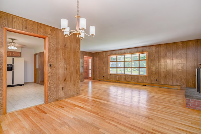 66 Hobby Dr, Ridgefield, CT 06877 - spare room with wooden walls, light wood-style flooring, a chandelier, and baseboards