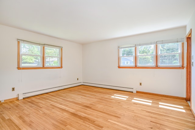 66 Hobby Dr, Ridgefield, CT 06877 - empty room featuring healthy amount of natural light, a baseboard heating unit, and light wood-type flooring
