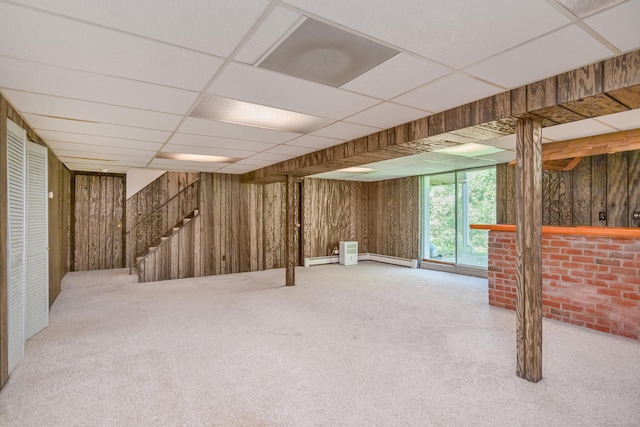 66 Hobby Dr, Ridgefield, CT 06877 - below grade area featuring carpet, wood walls, a paneled ceiling, baseboard heating, and stairway