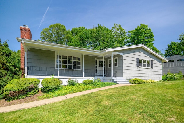 66 Hobby Dr, Ridgefield, CT 06877 - single story home with a chimney, a front lawn, and a porch