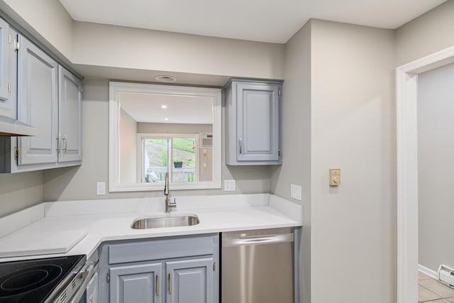 55 Mill Plain Rd Unit 34-14, Danbury, CT 06811 - kitchen with dishwasher, a sink, gray cabinets, a baseboard radiator, and light countertops