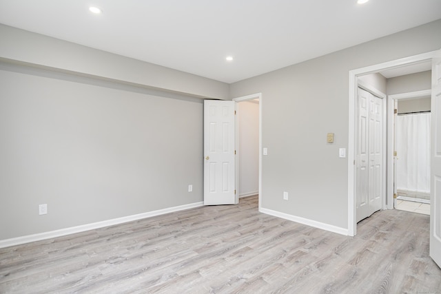 55 Mill Plain Rd Unit 34-14, Danbury, CT 06811 - unfurnished bedroom with light wood finished floors, recessed lighting, baseboards, and ensuite bath