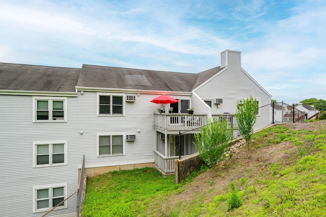 55 Mill Plain Rd Unit 34-14, Danbury, CT 06811 - back of house with a chimney, a deck, and a shingled roof