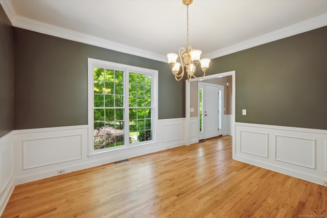 67 Bartman Rd, Haddam, CT 06441 - unfurnished dining area with ornamental molding, a chandelier, light wood finished floors, and wainscoting