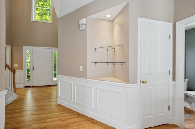 67 Bartman Rd, Haddam, CT 06441 - entryway featuring plenty of natural light, stairway, wainscoting, light wood-style flooring, and high vaulted ceiling