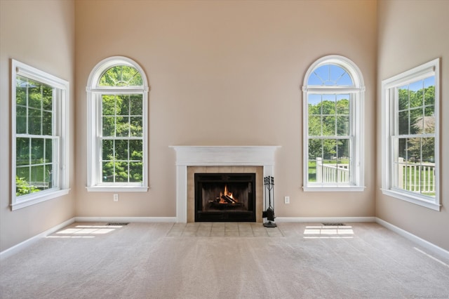 67 Bartman Rd, Haddam, CT 06441 - unfurnished living room with carpet, a tile fireplace, healthy amount of natural light, and a towering ceiling