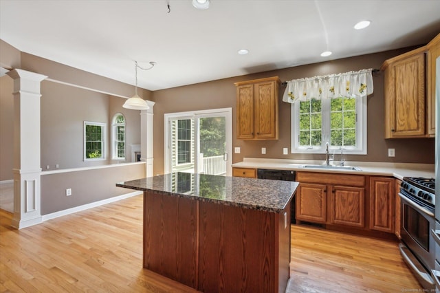 67 Bartman Rd, Haddam, CT 06441 - kitchen with a sink, gas range, light wood-style flooring, decorative columns, and hanging light fixtures