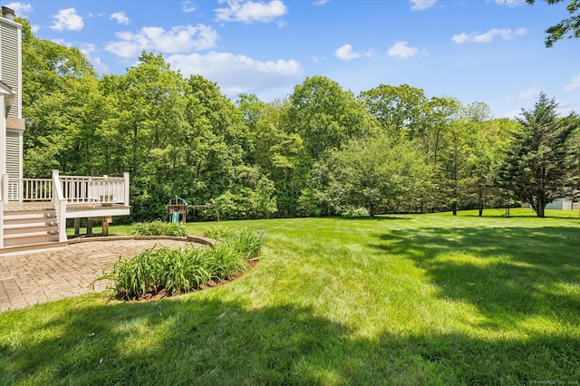 67 Bartman Rd, Haddam, CT 06441 - view of grassy yard with a playground, a deck, a patio area, and a wooded view