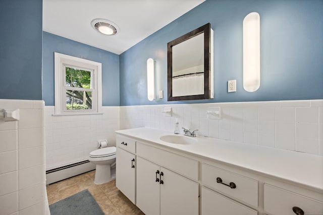881 Pine St, Bristol, CT 06010 - full bath with a baseboard heating unit, vanity, tile walls, and a wainscoted wall