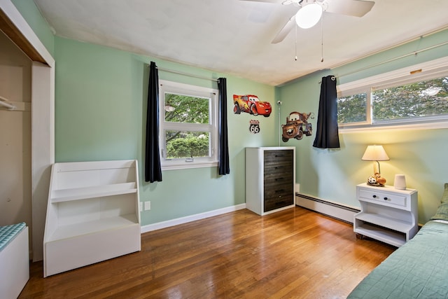 881 Pine St, Bristol, CT 06010 - bedroom featuring baseboard heating, wood finished floors, a ceiling fan, and a closet