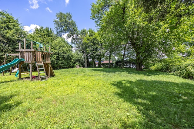 881 Pine St, Bristol, CT 06010 - view of green lawn with a playground and view of scattered trees