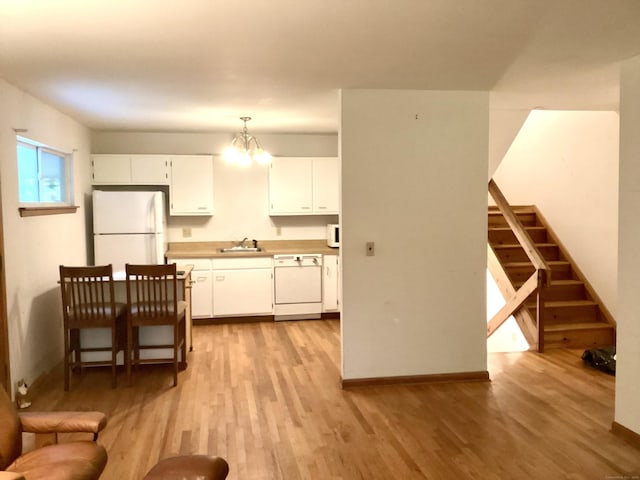 322 N St, Roxbury, CT 06783 - kitchen featuring white appliances, a sink, light wood-type flooring, and white cabinets