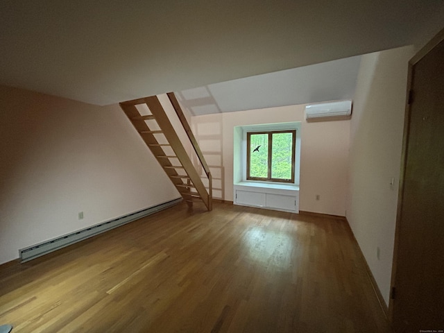 322 N St, Roxbury, CT 06783 - empty room featuring a wall unit AC, a baseboard radiator, and wood finished floors
