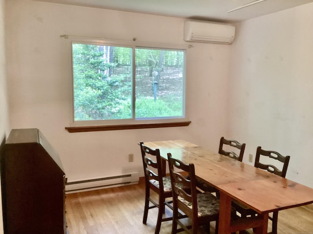 322 N St, Roxbury, CT 06783 - dining space with a baseboard heating unit, an AC wall unit, and light wood-type flooring
