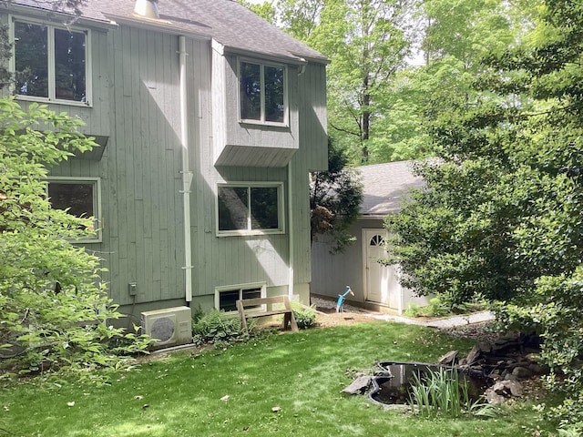 322 N St, Roxbury, CT 06783 - back of house with ac unit, a shingled roof, and a yard