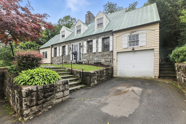 567 Bunker Hill Ave, Waterbury, CT 06708 - new england style home with an attached garage, asphalt driveway, a chimney, a metal roof, and a standing seam roof