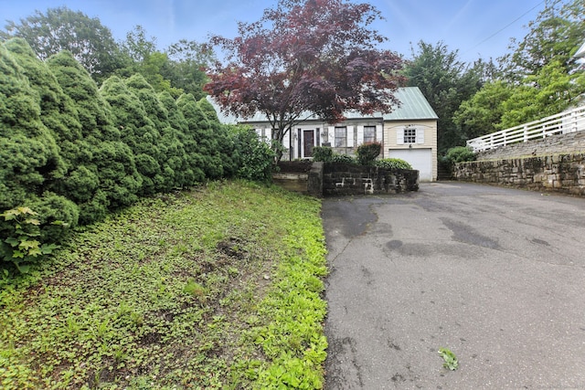567 Bunker Hill Ave, Waterbury, CT 06708 - view of front of home featuring driveway, an attached garage, and a metal roof