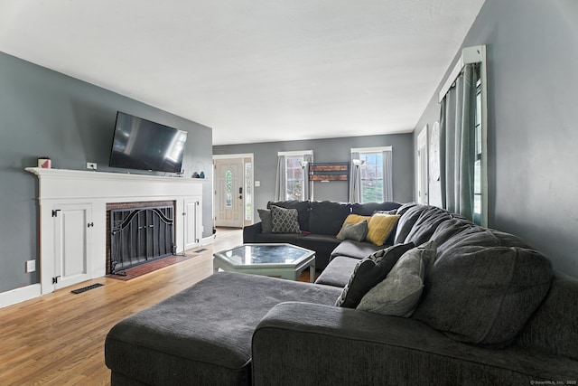 567 Bunker Hill Ave, Waterbury, CT 06708 - living room with light wood-type flooring and a fireplace with flush hearth