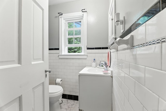 567 Bunker Hill Ave, Waterbury, CT 06708 - bathroom featuring vanity, tile walls, wainscoting, and marble look tiles