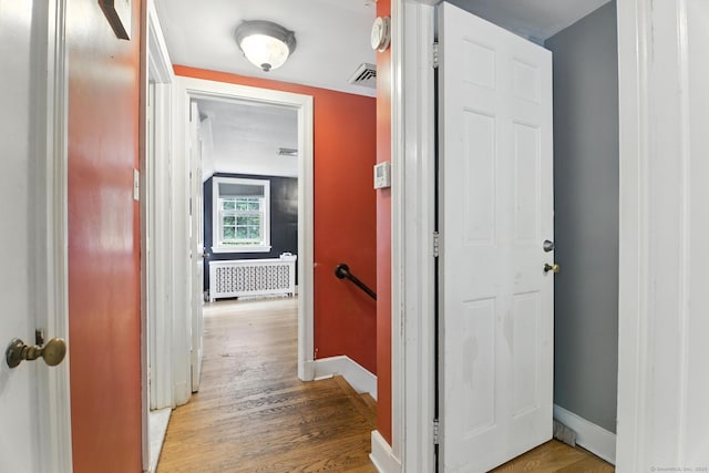 567 Bunker Hill Ave, Waterbury, CT 06708 - corridor featuring radiator heating unit, an upstairs landing, and wood finished floors
