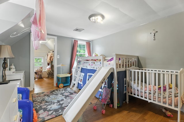 567 Bunker Hill Ave, Waterbury, CT 06708 - bedroom with multiple windows, wood finished floors, and vaulted ceiling