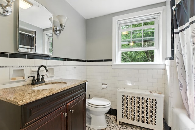 567 Bunker Hill Ave, Waterbury, CT 06708 - bathroom featuring radiator heating unit, tile walls, vanity, a wainscoted wall, and shower / bath combo