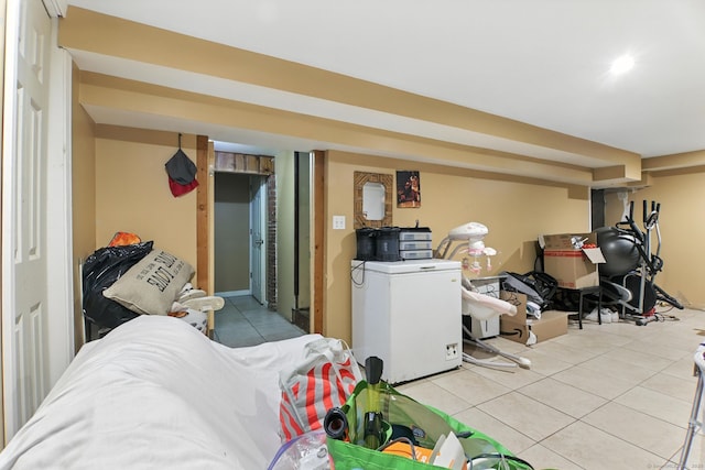 567 Bunker Hill Ave, Waterbury, CT 06708 - finished basement featuring fridge and light tile patterned floors