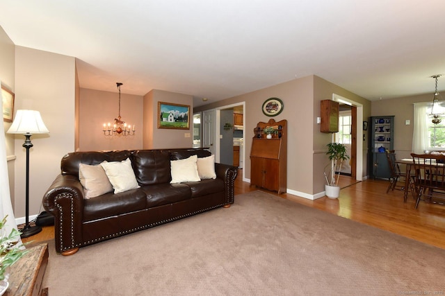 10 Brewer Rd, East Hampton, CT 06424 - carpeted living area with a chandelier, wood finished floors, and baseboards