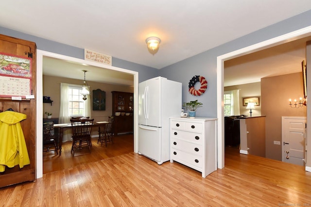 10 Brewer Rd, East Hampton, CT 06424 - kitchen with freestanding refrigerator, light wood-style floors, a chandelier, and light countertops