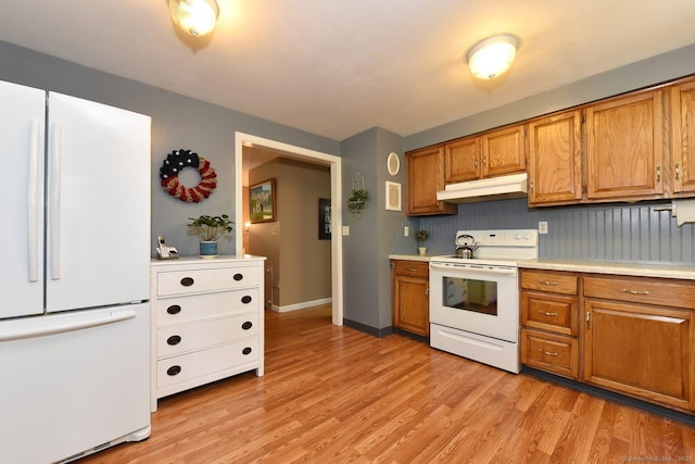 10 Brewer Rd, East Hampton, CT 06424 - kitchen featuring white appliances, under cabinet range hood, brown cabinetry, and light countertops