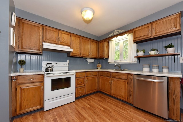 10 Brewer Rd, East Hampton, CT 06424 - kitchen with dishwasher, electric stove, under cabinet range hood, a sink, and brown cabinetry