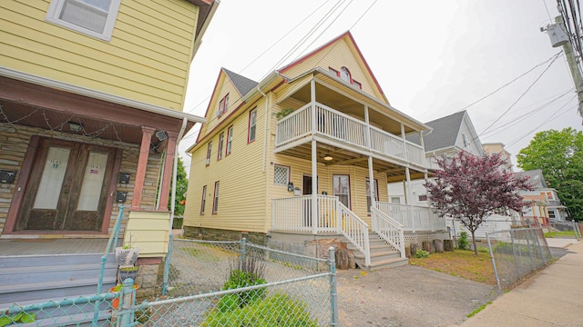 1149 Central Ave, Bridgeport, CT 06607 - view of front of house with covered porch, a balcony, and a gate