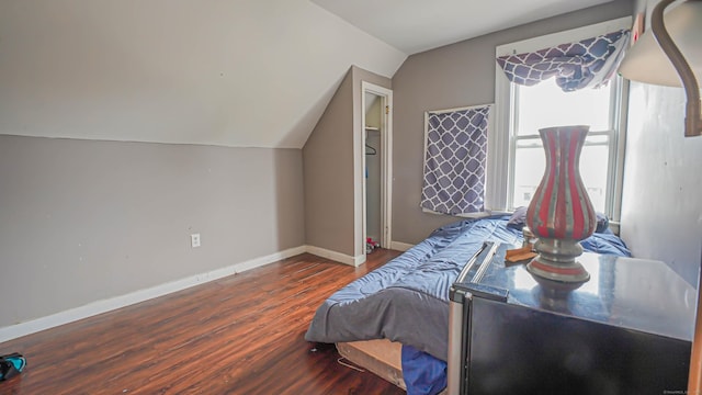 1149 Central Ave, Bridgeport, CT 06607 - bedroom featuring multiple windows, wood finished floors, vaulted ceiling, and baseboards