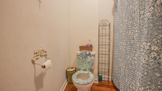 1149 Central Ave, Bridgeport, CT 06607 - bathroom with toilet, wood finished floors, and baseboards