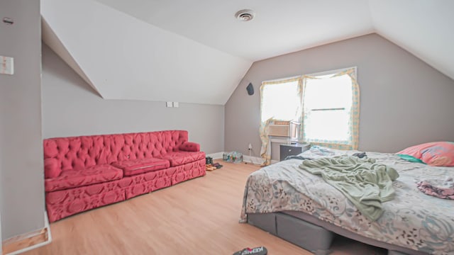 1149 Central Ave, Bridgeport, CT 06607 - bedroom with wood finished floors, vaulted ceiling, cooling unit, and baseboards