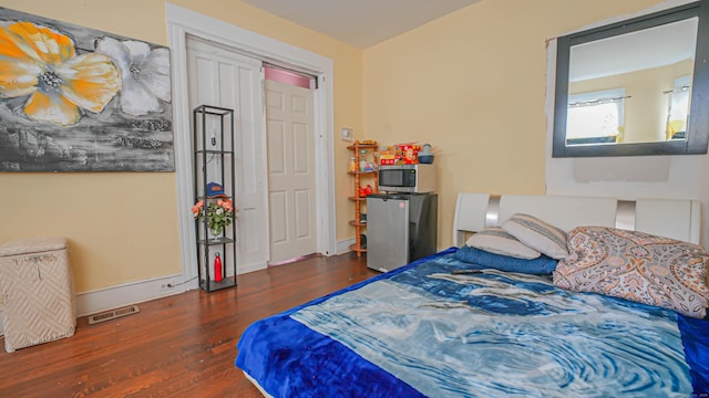 1149 Central Ave, Bridgeport, CT 06607 - bedroom featuring wood finished floors, fridge, and baseboards