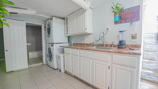 1149 Central Ave, Bridgeport, CT 06607 - laundry area with stacked washing machine and dryer and light tile patterned floors