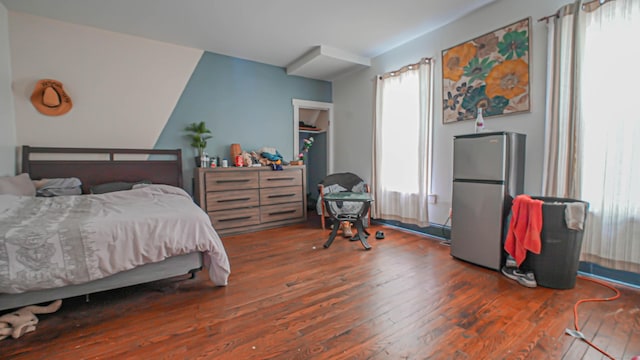 1149 Central Ave, Bridgeport, CT 06607 - bedroom featuring freestanding refrigerator, wood finished floors, and multiple windows