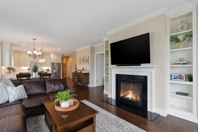 788 Farmington Ave Apt 202, Farmington, CT 06032 - living room featuring built in features, a lit fireplace, dark wood-style floors, a chandelier, and crown molding