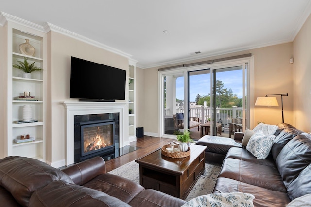 788 Farmington Ave Apt 202, Farmington, CT 06032 - living area featuring wood finished floors, a glass covered fireplace, ornamental molding, baseboards, and built in shelves
