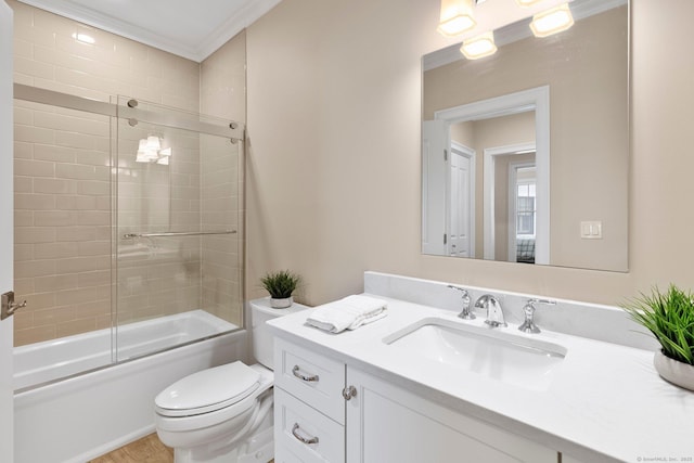 788 Farmington Ave Apt 202, Farmington, CT 06032 - bathroom featuring vanity, toilet, combined bath / shower with glass door, ornamental molding, and wood finished floors