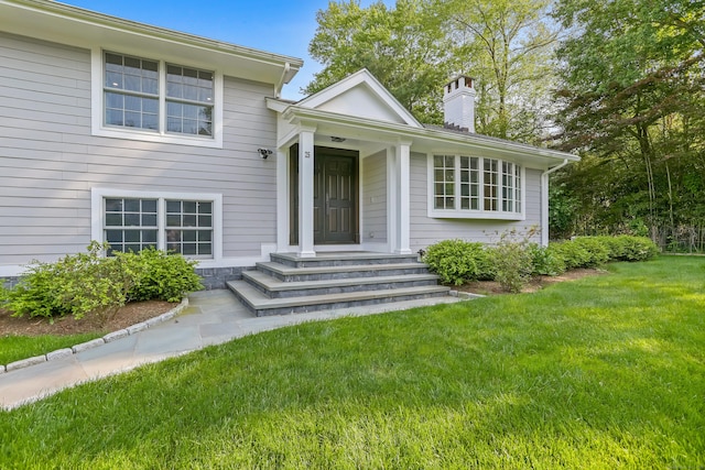 25 Conrad Rd, New Canaan, CT 06840 - tri-level home featuring a front yard and a chimney